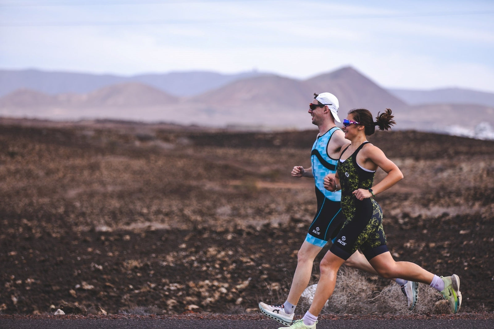 Triathletes running in tri suits during endurance training, highlighting healthy running form and injury prevention